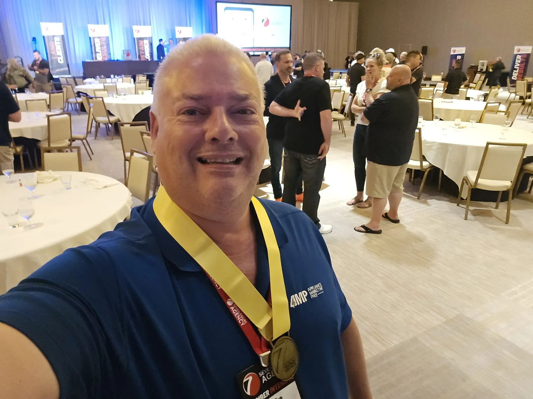 Mike Carson wearing the Seven Figure Agency Milestone Award medal at the 2026 event