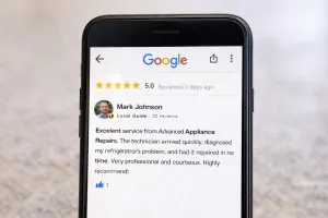 Smartphone screen displaying a five-star Google review for an appliance repair company.