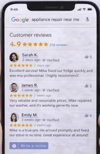 Mobile phone displaying five-star customer reviews for appliance repair business